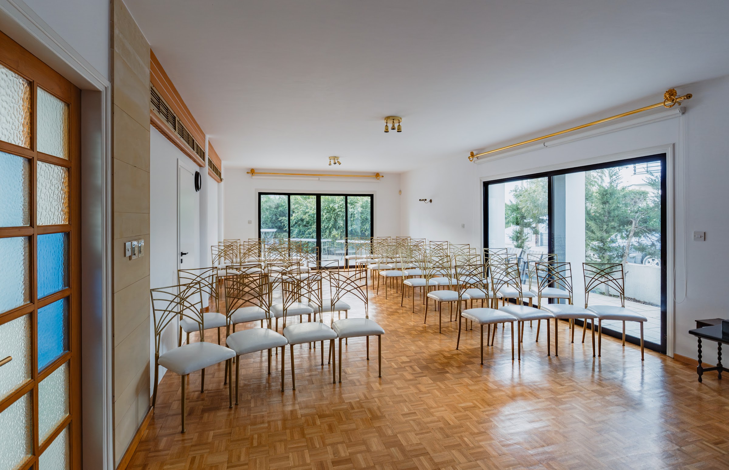 Second rehearsal hall: spacious room with gold seating, natural light from floor-to-ceiling windows and garden views